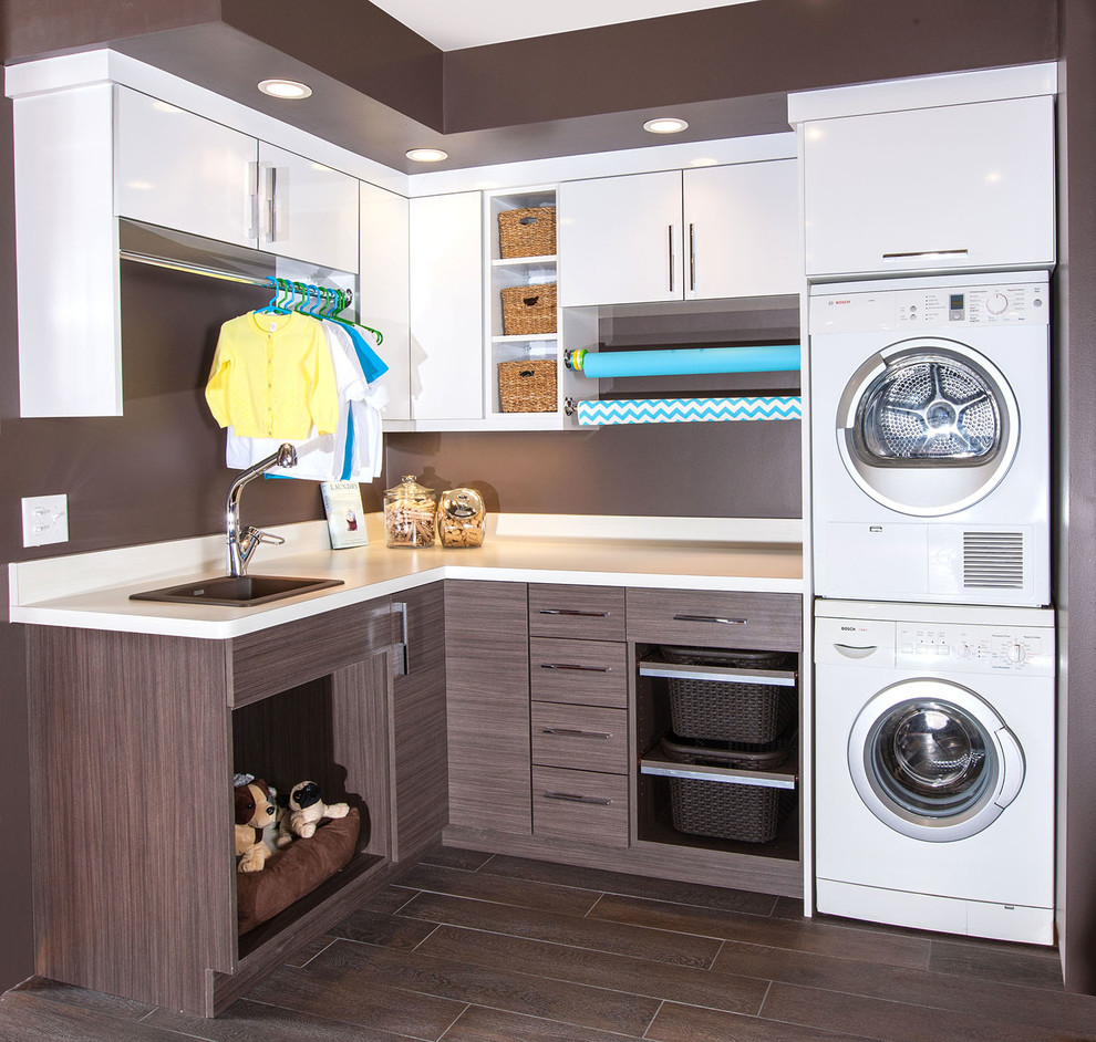 This is an example of a mid-sized contemporary l-shaped utility room in Minneapolis with a drop-in sink, flat-panel cabinets, white cabinets, laminate benchtops, brown walls, porcelain floors and a stacked washer and dryer.