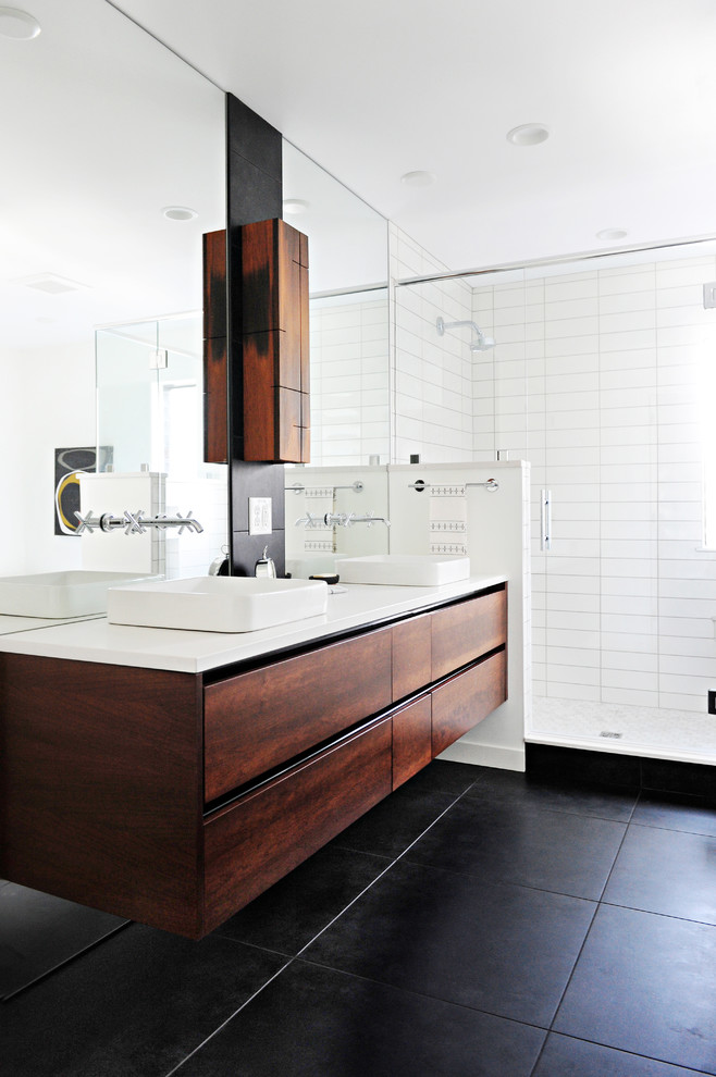 Bathroom - mid-sized contemporary master porcelain tile and white tile porcelain tile and black floor bathroom idea in Indianapolis with flat-panel cabinets, brown cabinets, a vessel sink, quartz countertops, a hinged shower door and white countertops