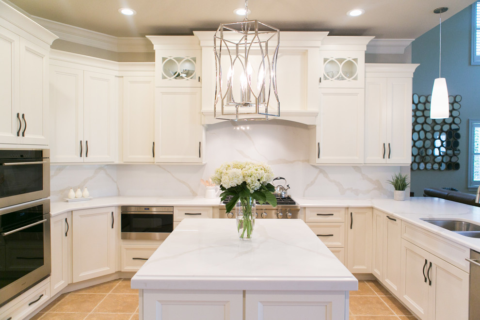 Photo of a mid-sized transitional u-shaped open plan kitchen in Orlando with an undermount sink, recessed-panel cabinets, white cabinets, quartzite benchtops, white splashback, stone slab splashback, stainless steel appliances and a peninsula.