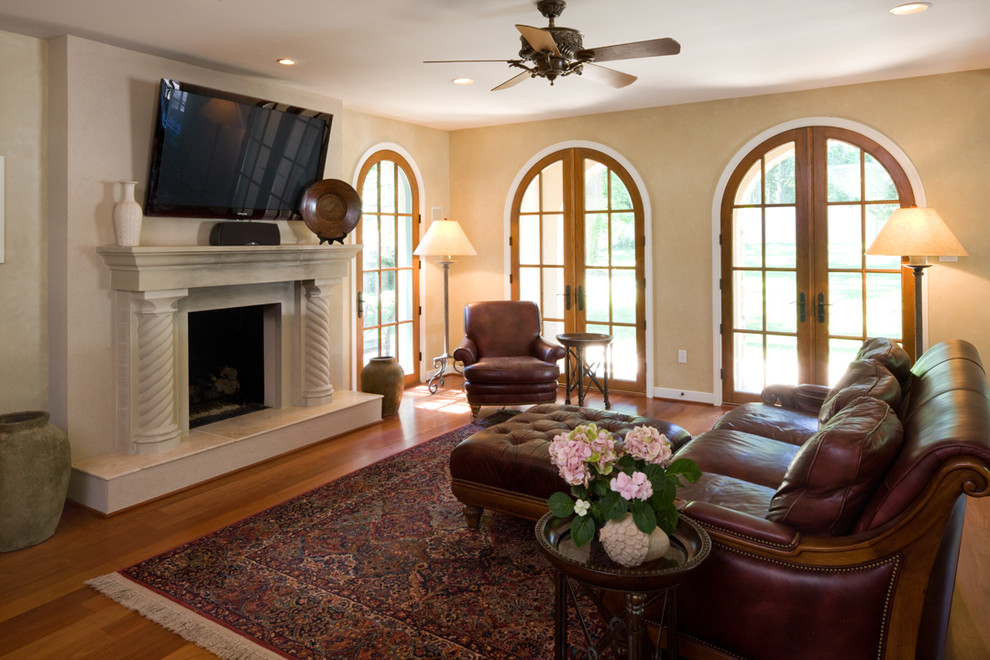 Large mediterranean living room in Baltimore with beige walls and a wall-mounted tv.