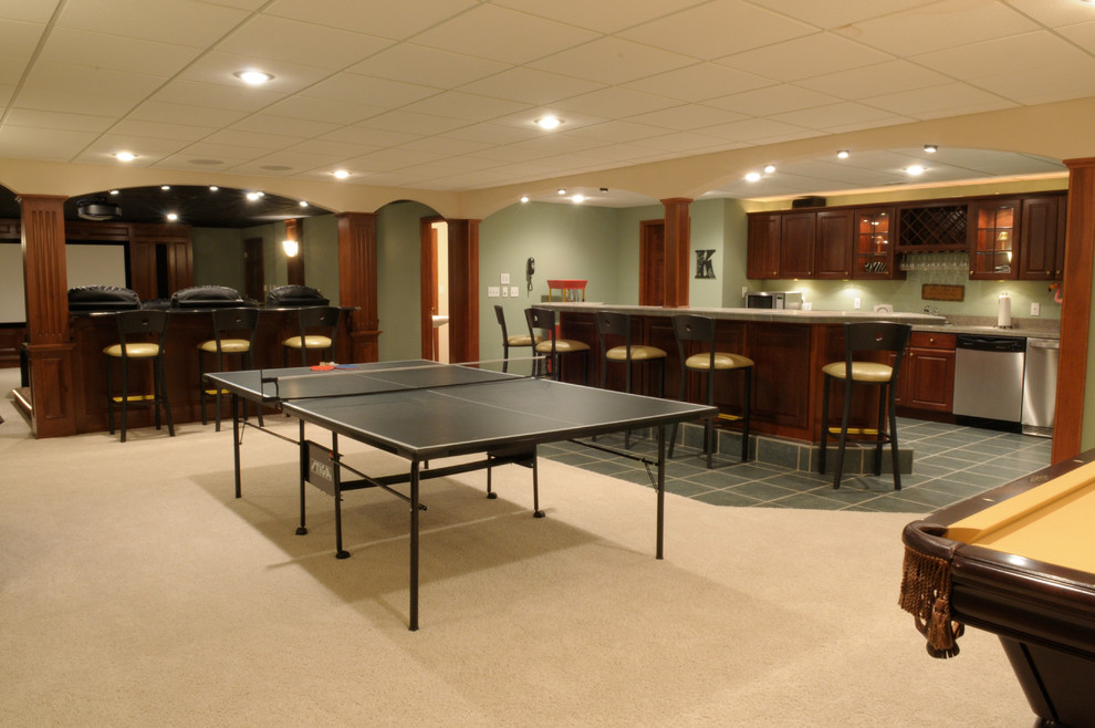 Basement - large transitional underground carpeted and beige floor basement idea with green walls and no fireplace