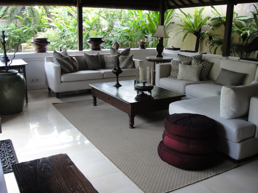 Example of an island style living room design in Other