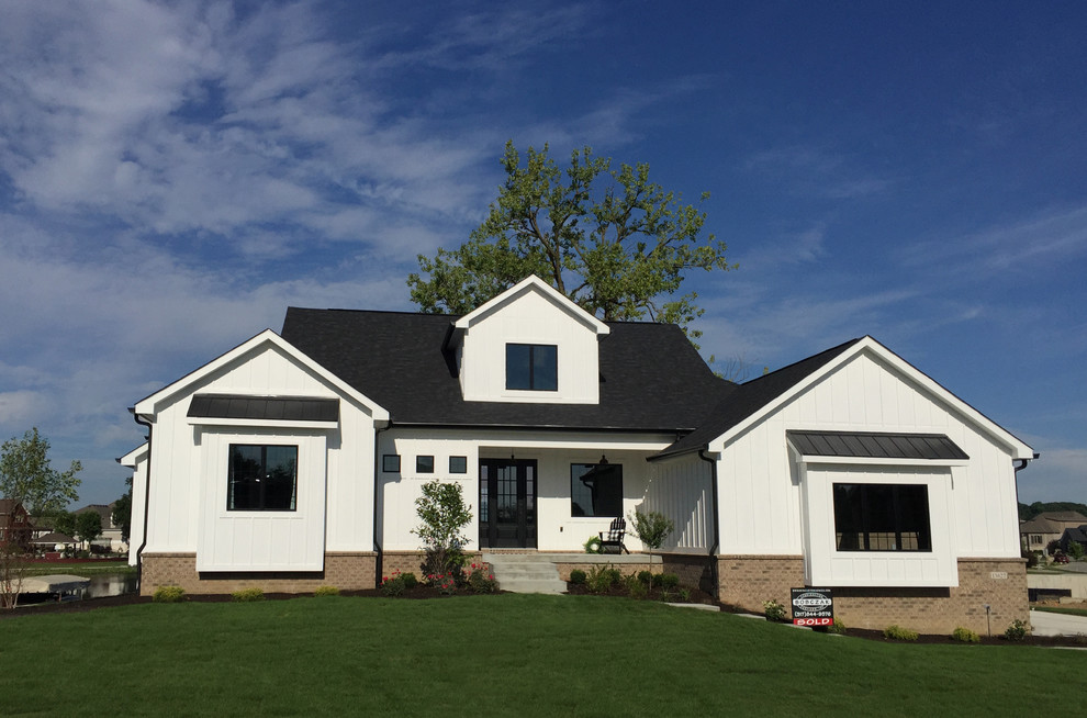 Mid-sized country one-storey white house exterior in Indianapolis with concrete fiberboard siding and a shingle roof.