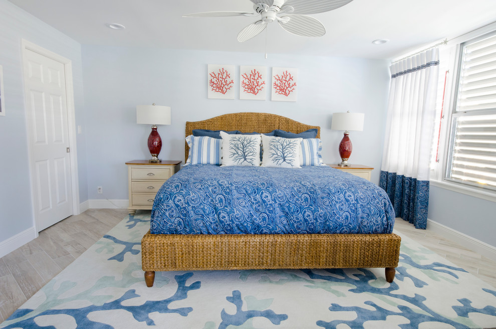 Inspiration for a large beach style master bedroom in Miami with blue walls and ceramic floors.