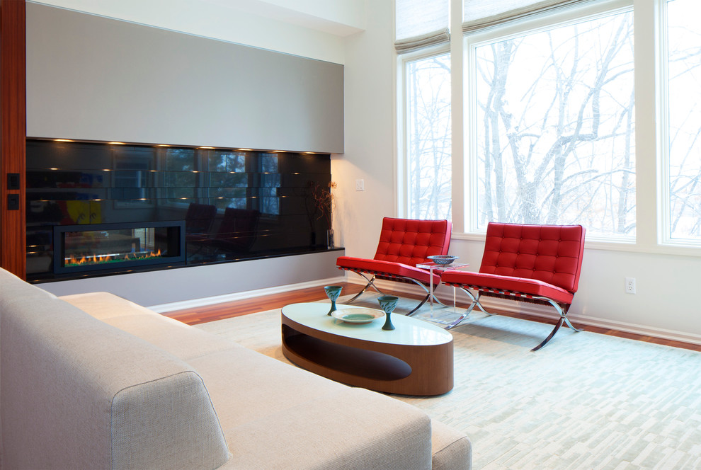 Photo of a modern living room in Minneapolis with a ribbon fireplace.