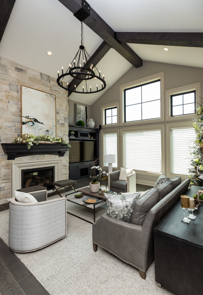 Inspiration for a large transitional formal enclosed living room in Other with grey walls, dark hardwood floors, a standard fireplace, a stone fireplace surround, brown floor and a built-in media wall.