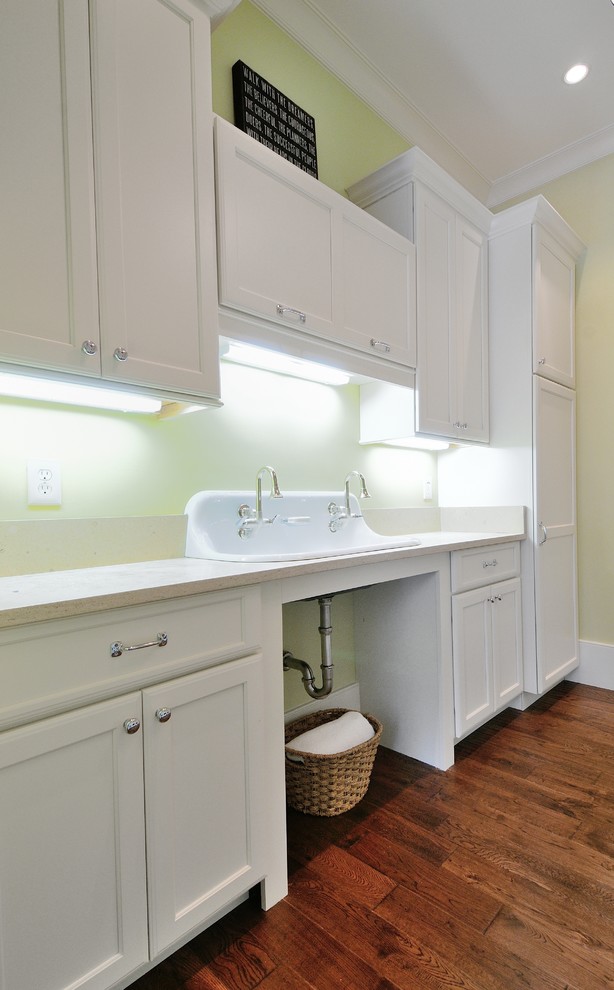 Inspiration for a mid-sized country single-wall dedicated laundry room in Atlanta with a drop-in sink, shaker cabinets, white cabinets, quartz benchtops, green walls, medium hardwood floors and a side-by-side washer and dryer.