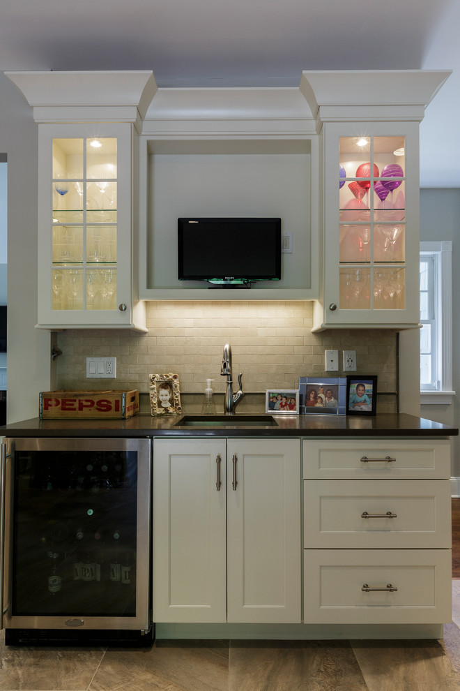 Inspiration for a mid-sized rustic l-shaped porcelain tile and beige floor open concept kitchen remodel in Bridgeport with an undermount sink, shaker cabinets, white cabinets, granite countertops, beige backsplash, porcelain backsplash, stainless steel appliances and an island
