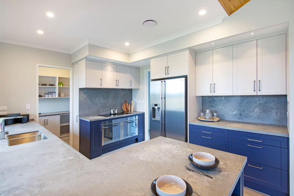 This is an example of a large country kitchen pantry in Other with a double-bowl sink, shaker cabinets, blue cabinets, quartz benchtops, grey splashback, stone slab splashback, stainless steel appliances, porcelain floors, grey floor and grey benchtop.