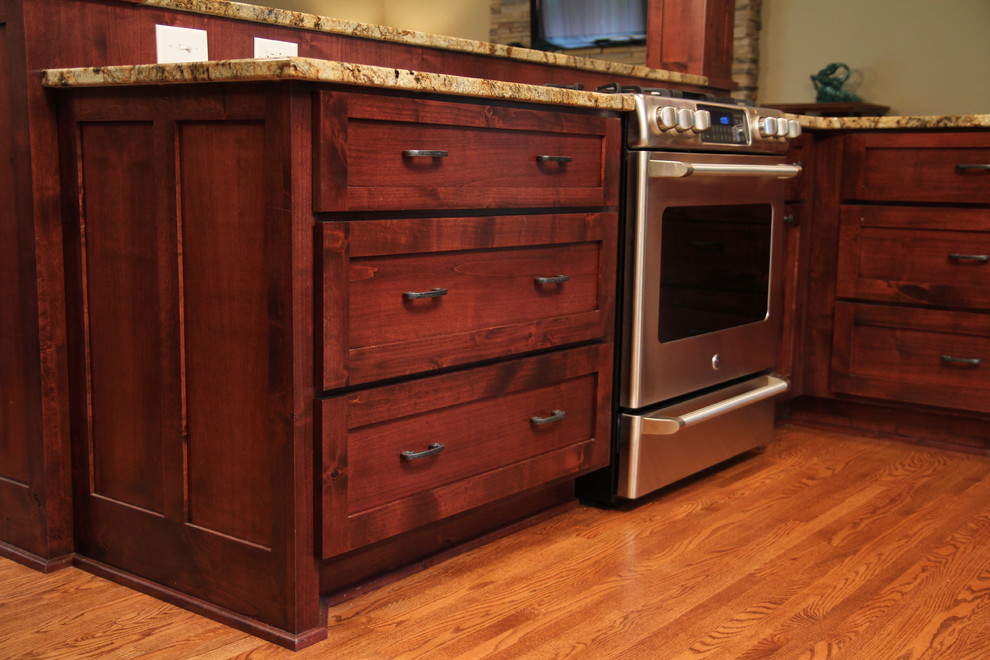 Mountain style kitchen photo in Minneapolis with a farmhouse sink, flat-panel cabinets and medium tone wood cabinets