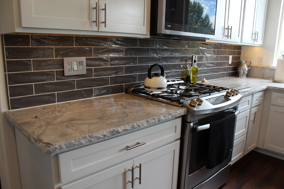 Open concept kitchen - mid-sized transitional l-shaped medium tone wood floor and brown floor open concept kitchen idea with an undermount sink, marble countertops, gray backsplash, ceramic backsplash, stainless steel appliances and an island