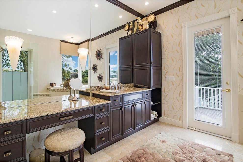 Large traditional master bathroom in Miami with an undermount sink, recessed-panel cabinets, dark wood cabinets, granite benchtops, a corner tub, a curbless shower, beige tile, porcelain tile, a one-piece toilet, beige walls and travertine floors.