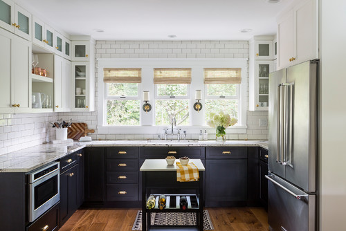 L-shaped kitchen with two-tone black and white cabinets