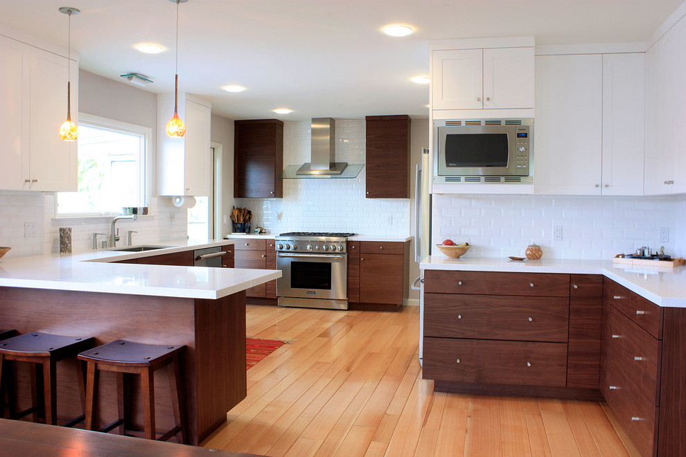 Photo of a contemporary kitchen in San Francisco with subway tile splashback and stainless steel appliances.