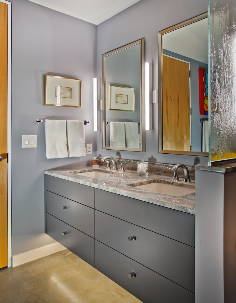 Mid-sized transitional master bathroom in Minneapolis with flat-panel cabinets, grey cabinets, a curbless shower, a two-piece toilet, grey walls, concrete floors, an undermount sink, granite benchtops, a hinged shower door and grey benchtops.