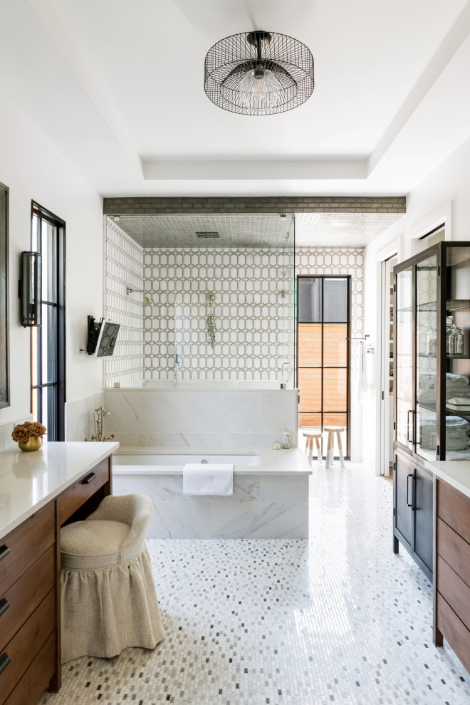 Inspiration for a mid-sized transitional master white tile double-sink, tray ceiling and multicolored floor bathroom remodel in Dallas with flat-panel cabinets, medium tone wood cabinets, a built-in vanity, an undermount tub, a two-piece toilet, white walls, an undermount sink and beige countertops