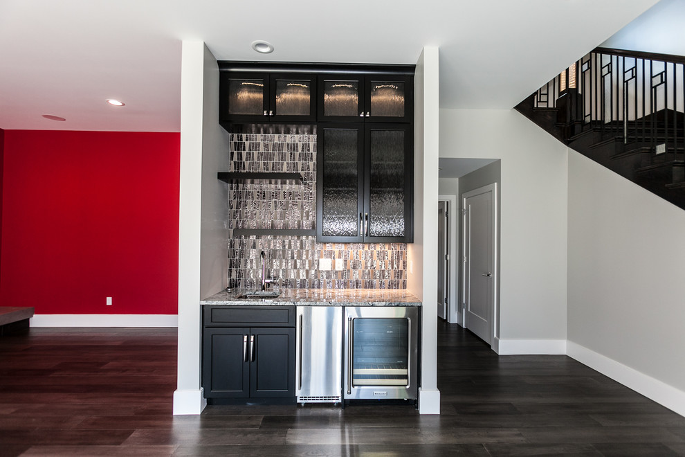 This is an example of a contemporary home bar in St Louis with glass tile splashback.
