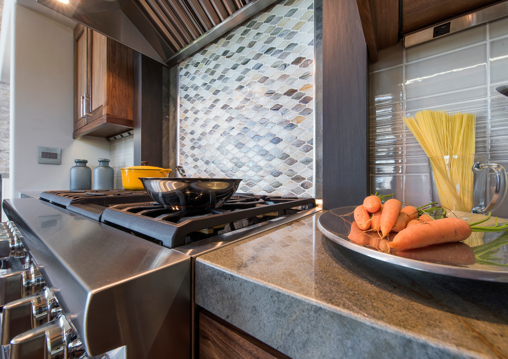 Open concept kitchen - large transitional l-shaped ceramic tile and gray floor open concept kitchen idea with an undermount sink, recessed-panel cabinets, dark wood cabinets, granite countertops, multicolored backsplash, mosaic tile backsplash, stainless steel appliances and an island