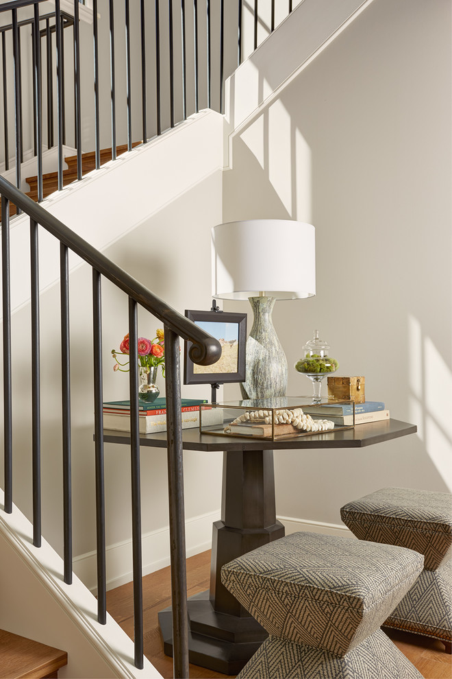 Huge wooden u-shaped metal railing staircase photo in Minneapolis with wooden risers