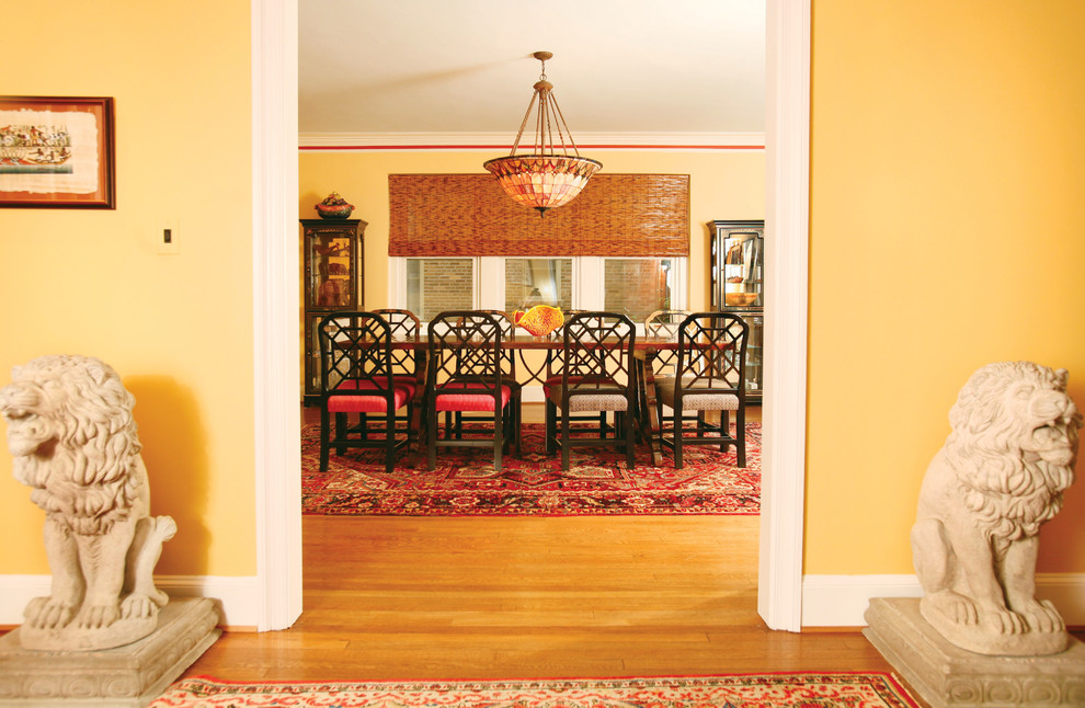 Inspiration for a contemporary dining room in DC Metro with yellow walls and medium hardwood floors.