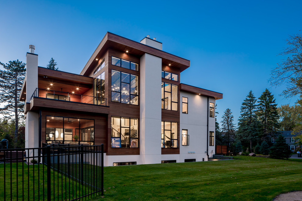 Expansive contemporary three-storey white exterior in Minneapolis with mixed siding and a flat roof.