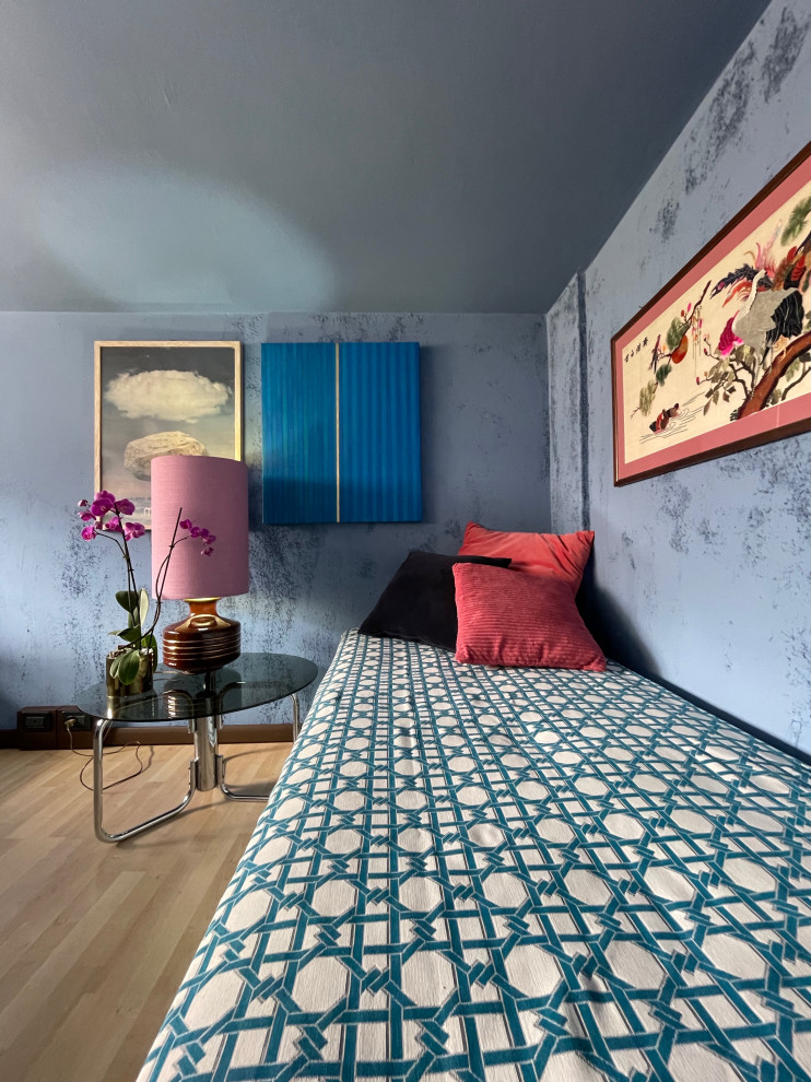 Small eclectic mezzanine bedroom in Other with blue walls, laminate floors, beige floors and a drop ceiling.