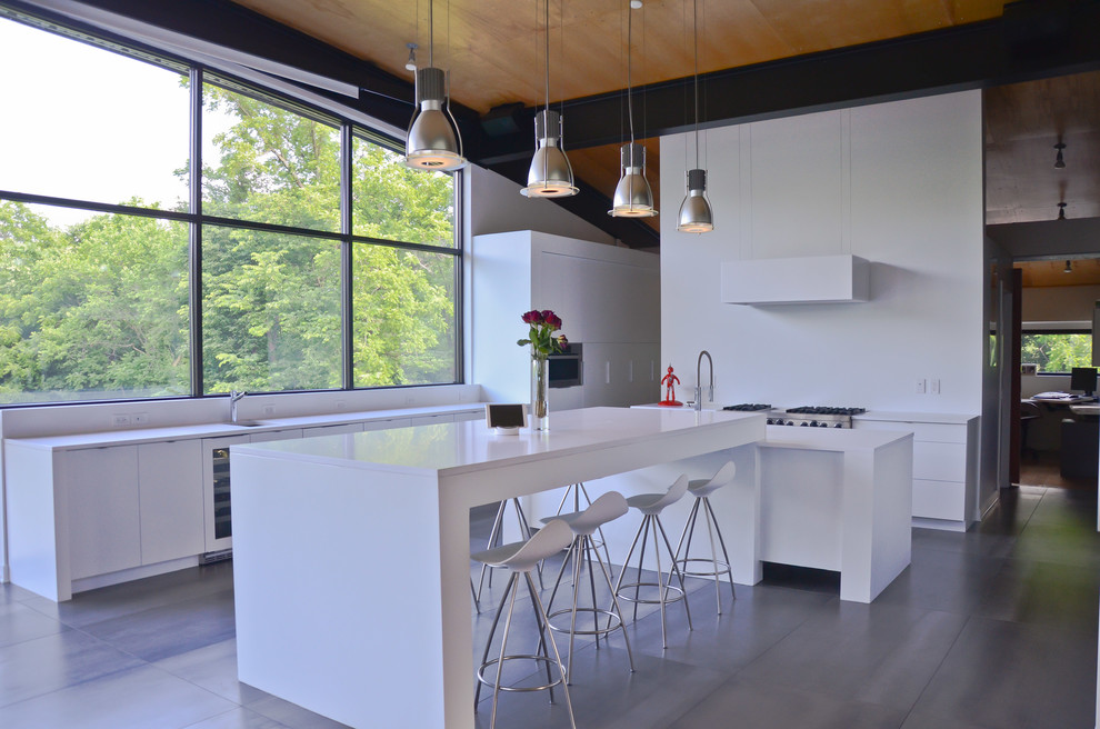 Large trendy porcelain tile and gray floor eat-in kitchen photo in Kansas City with an undermount sink, flat-panel cabinets, white cabinets, quartz countertops, stainless steel appliances and two islands