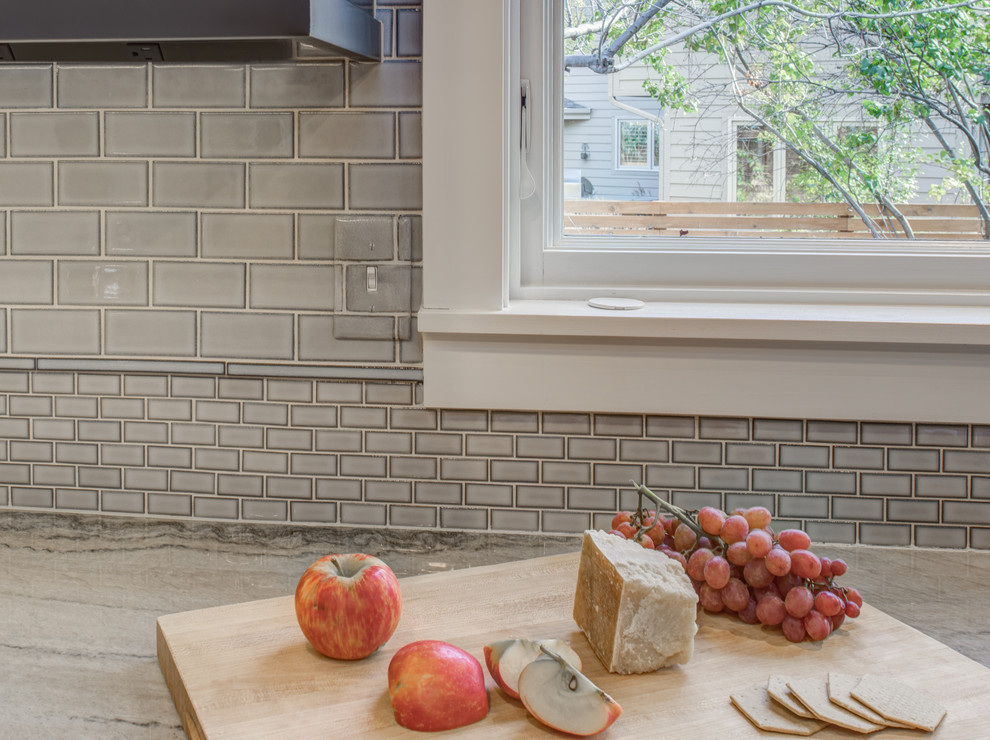 Inspiration for a large transitional u-shaped light wood floor eat-in kitchen remodel in Denver with a farmhouse sink, recessed-panel cabinets, gray cabinets, quartzite countertops, blue backsplash, ceramic backsplash, stainless steel appliances and an island