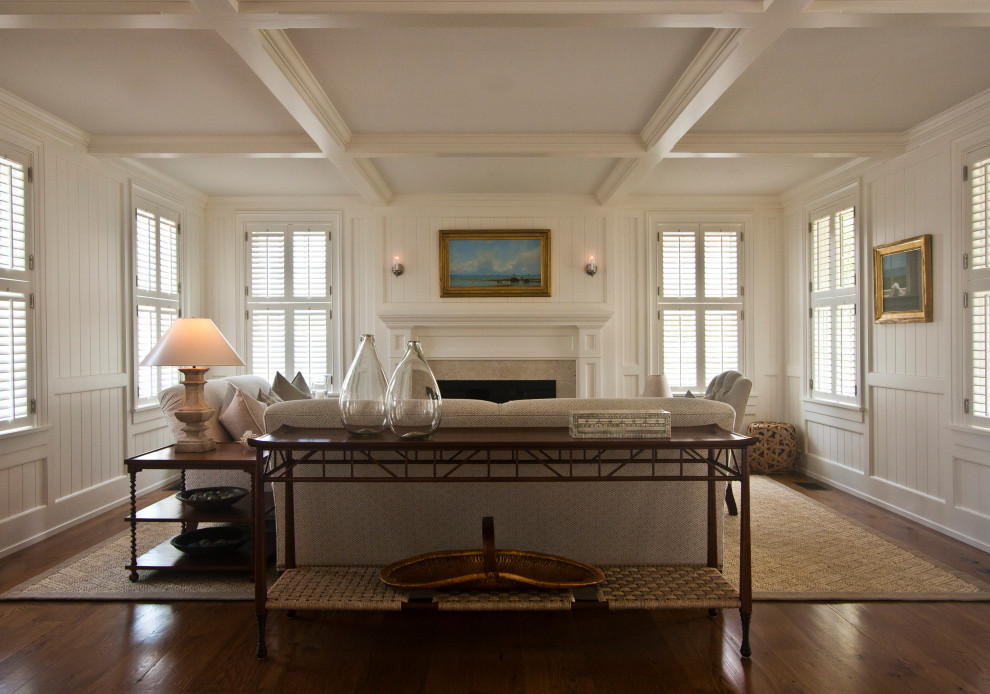 Inspiration for a large transitional formal enclosed living room in Boston with white walls, dark hardwood floors, a standard fireplace, a stone fireplace surround, no tv, brown floor and coffered.