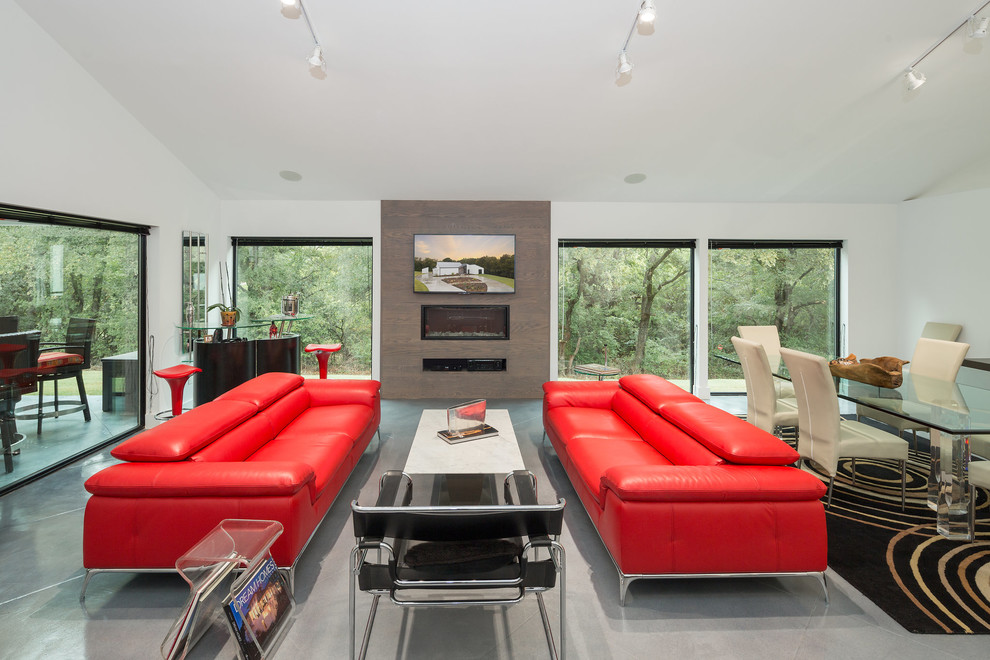 This is an example of a contemporary open concept living room in Dallas with white walls, a ribbon fireplace, a wall-mounted tv, grey floor, concrete floors and a home bar.