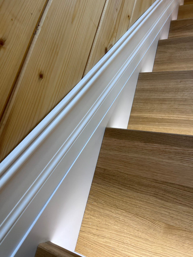 Idée de décoration pour un escalier design en L avec un garde-corps en bois.