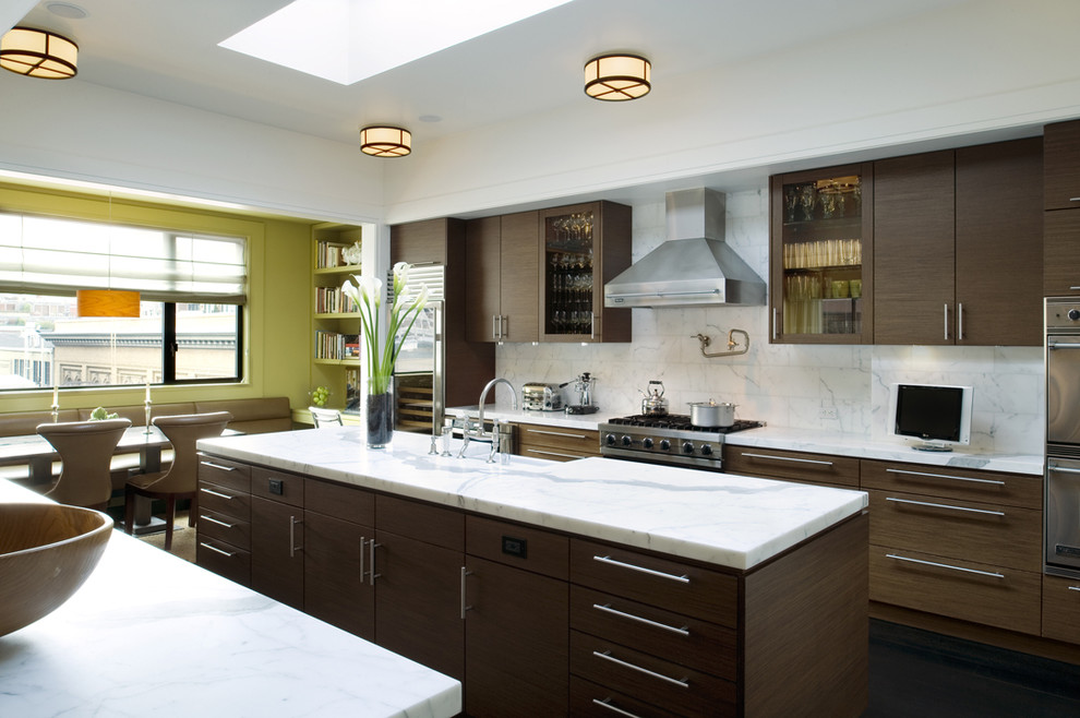 Design ideas for a modern galley eat-in kitchen in San Francisco with a farmhouse sink, flat-panel cabinets, dark wood cabinets, white splashback and stainless steel appliances.