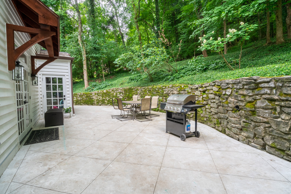 Inspiration for a large country backyard patio in Nashville with concrete pavers.