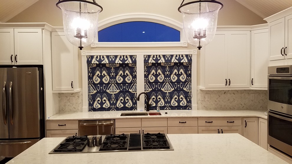Kitchen - transitional kitchen idea with an undermount sink, recessed-panel cabinets, white cabinets, marble countertops, white backsplash, stone tile backsplash, stainless steel appliances and an island