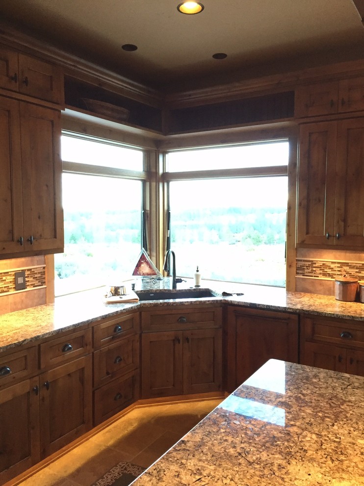 Inspiration for a mid-sized rustic porcelain tile and beige floor kitchen remodel with an undermount sink, recessed-panel cabinets, light wood cabinets, granite countertops, beige backsplash, matchstick tile backsplash, paneled appliances and an island