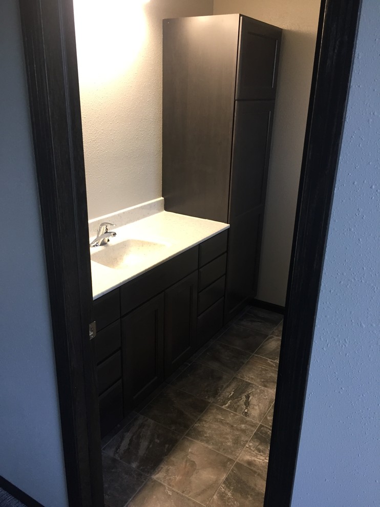 Mid-sized traditional master bathroom in Other with flat-panel cabinets, black cabinets, grey walls, ceramic floors, an integrated sink, onyx benchtops and grey floor.