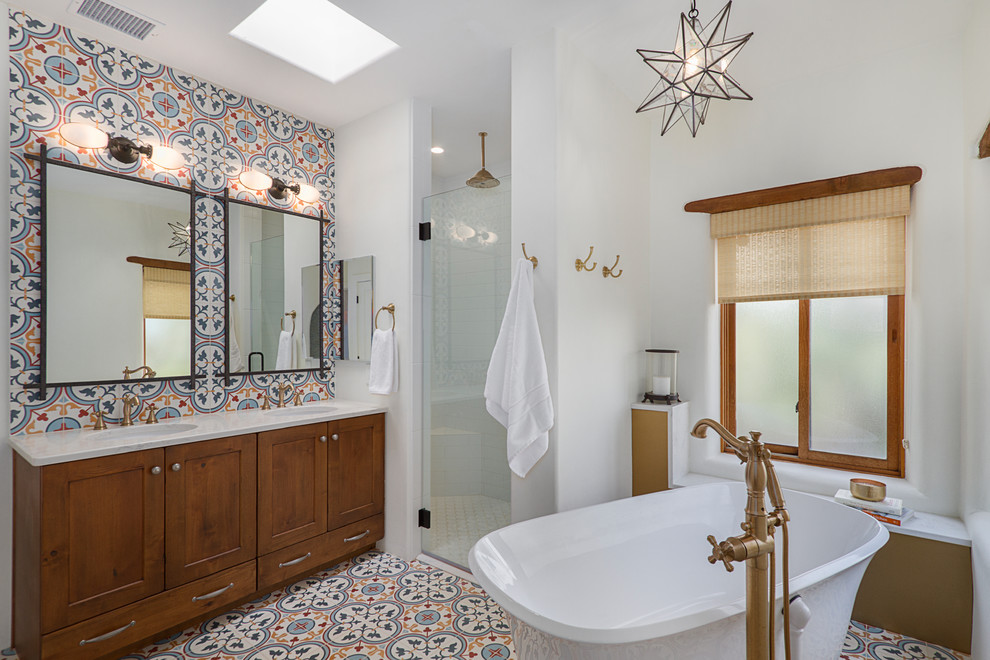 Inspiration for a mid-sized southwestern master multicolored tile and cement tile cement tile floor, multicolored floor and double-sink bathroom remodel in Phoenix with medium tone wood cabinets, an undermount sink, quartz countertops, a hinged shower door, white countertops, shaker cabinets and a built-in vanity