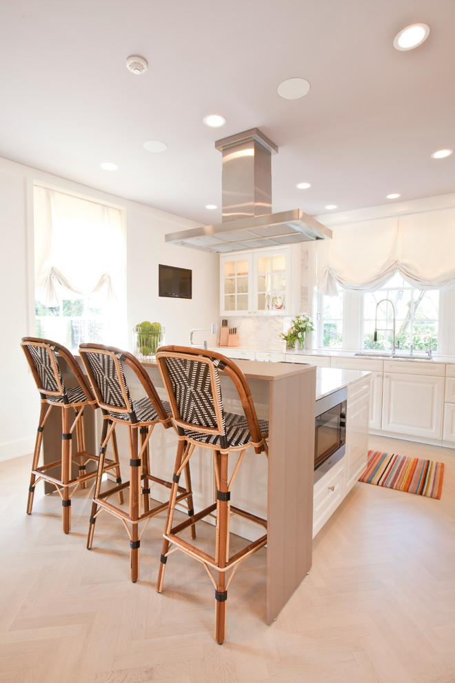 Photo of a transitional kitchen in Houston with raised-panel cabinets, white cabinets and white splashback.