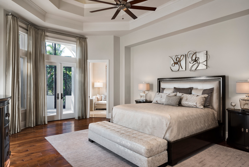 Photo of a transitional master bedroom in Miami with dark hardwood floors, brown floor and white walls.