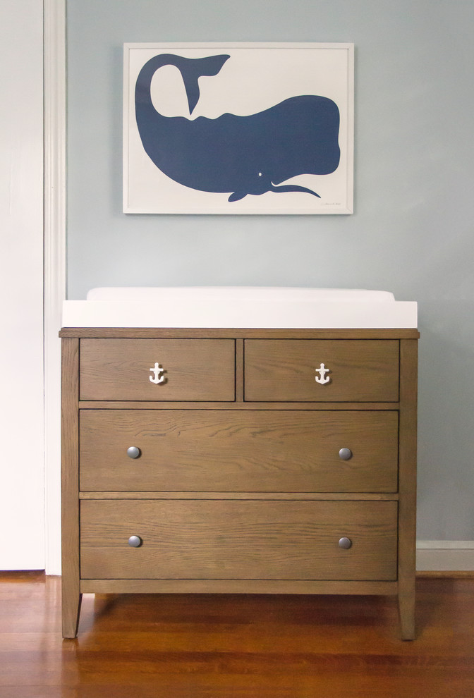 Small beach style gender-neutral medium tone wood floor nursery photo in DC Metro with blue walls