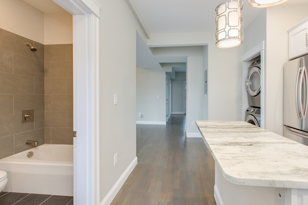 Enclosed kitchen - mid-sized transitional l-shaped dark wood floor and brown floor enclosed kitchen idea in Boston with an undermount sink, shaker cabinets, white cabinets, marble countertops, gray backsplash, subway tile backsplash, stainless steel appliances, an island and white countertops