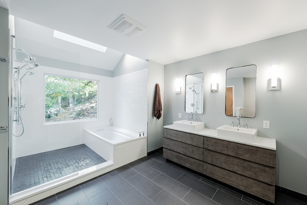 Photo of a large contemporary master wet room bathroom in New York with an alcove tub, a two-piece toilet, grey walls, ceramic floors, white tile, a vessel sink, an open shower, distressed cabinets, subway tile, solid surface benchtops, grey floor and flat-panel cabinets.