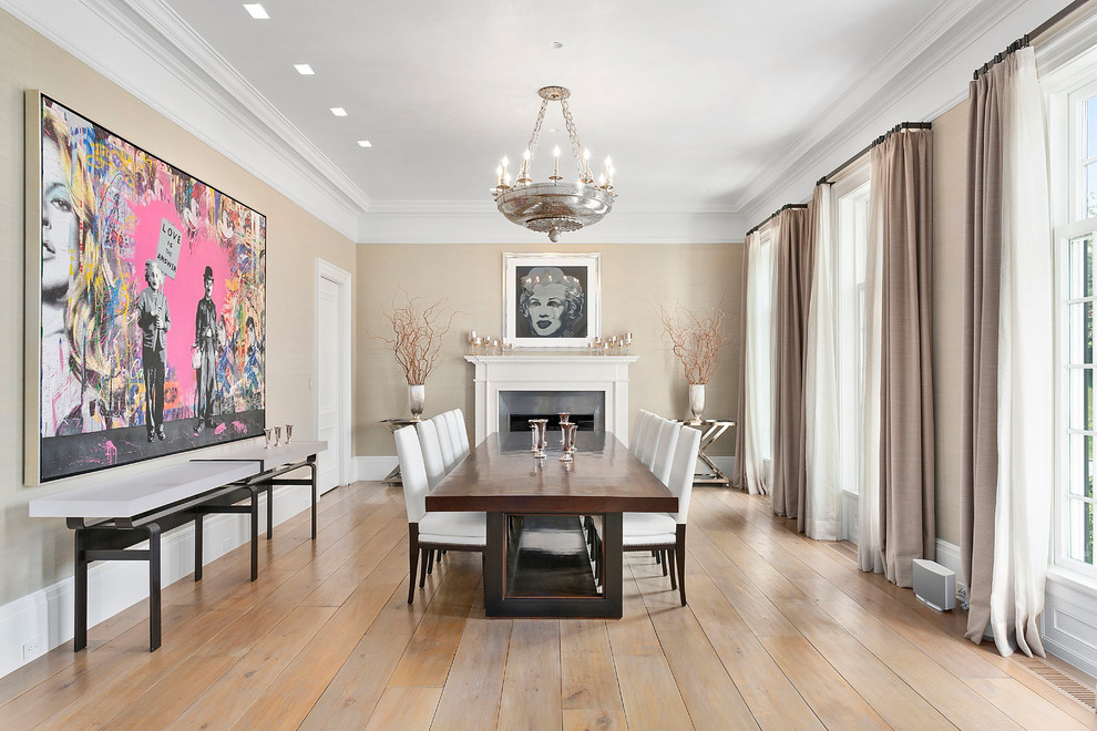 Inspiration for a transitional separate dining room in New York with beige walls, light hardwood floors, a standard fireplace and beige floor.
