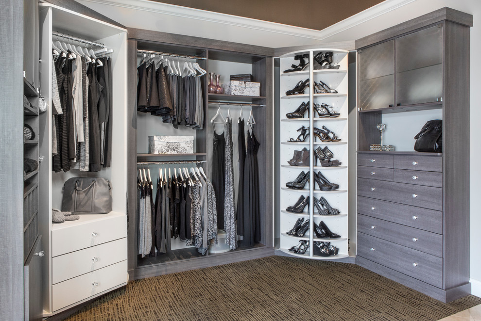 Photo of a mid-sized traditional women's walk-in wardrobe in Chicago with flat-panel cabinets, grey cabinets, carpet and multi-coloured floor.