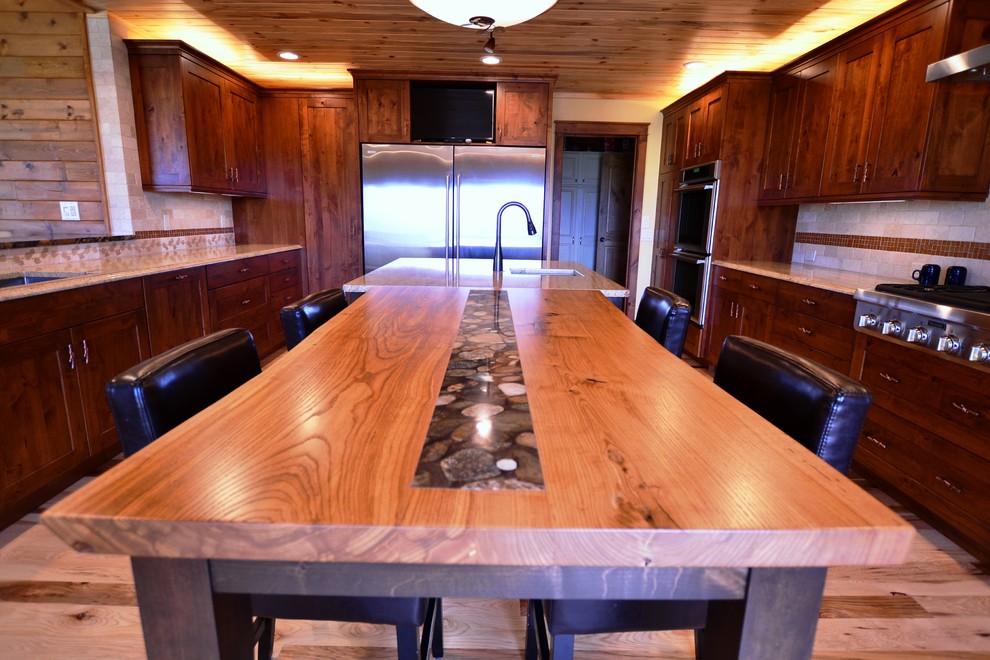 Kitchen - large rustic u-shaped medium tone wood floor kitchen idea with an undermount sink, flat-panel cabinets, medium tone wood cabinets, stainless steel appliances and an island