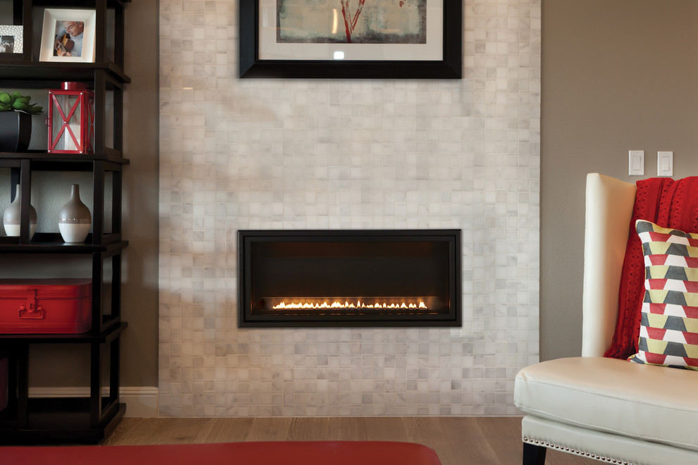 This is an example of a small contemporary formal open concept living room in Other with medium hardwood floors, a ribbon fireplace, no tv, brown floor, beige walls and a tile fireplace surround.