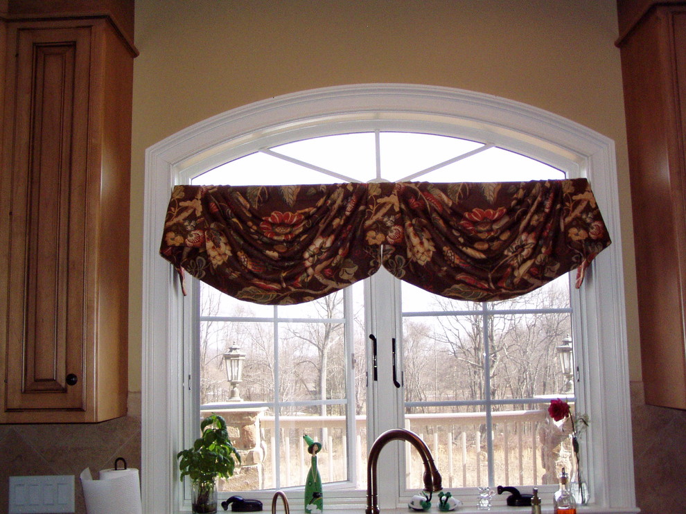 Inspiration for a transitional enclosed kitchen remodel with recessed-panel cabinets and medium tone wood cabinets