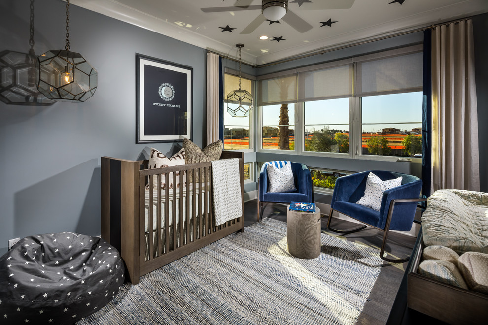 This is an example of a mid-sized contemporary gender-neutral nursery in Orange County with grey walls and medium hardwood floors.