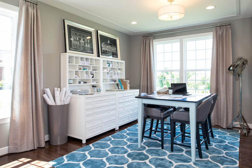 Inspiration for a traditional craft room in DC Metro with grey walls, dark hardwood floors and a freestanding desk.