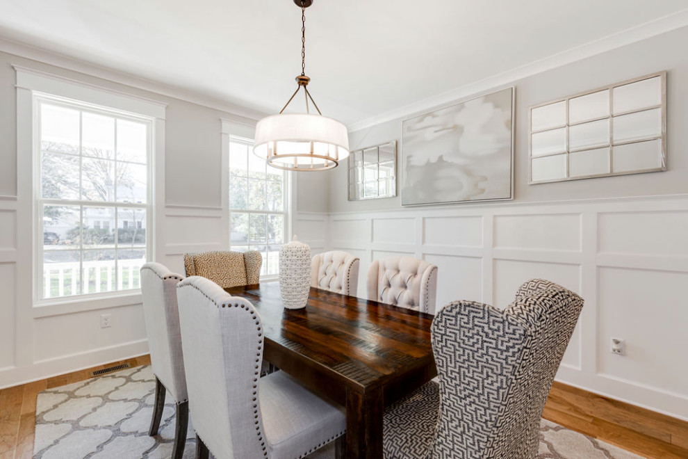 Design ideas for a medium sized traditional enclosed dining room in Richmond with grey walls, medium hardwood flooring, brown floors and wainscoting.